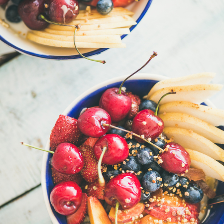 Healthy breakfast smoothie bowl with fresh fruit and berries, bee pollen and honey on wooden background, top view, square crop. Clean eating, weight loss, alcaline diet, fitness nutrition conceptの写真素材