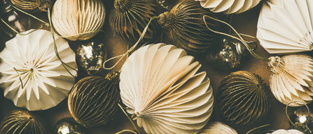 Christmas or New Year holiday background, texture and wallpaper. Flat-lay of paper white and golden christmas tree decoration toys, top view, close-up. New year greeting card concept, festive moodの写真素材