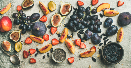 Healthy seasonal fall breakfast variety. Flat-lay of Greek yogurt, fresh fruit, chia seeds over grey concrete background, top view, copy space. Clean eating, dieting, vegetarian foodの写真素材