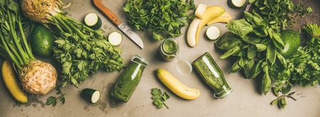 Making green detox smoothie. Flat-lay of ingredients for making smoothie drink over grey concrete background, top view, copy space. Healthy, clean eating, weight loss food conceptの写真素材
