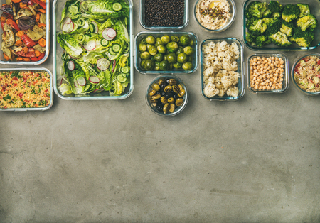 Healthy vegan dishes in containers. Flat-lay of vegetable salad, legumes, beans, olives, sprouts, hummus dip, couscous for take-away lunch, top view, copy space. Spring menu, dieting food conceptの写真素材