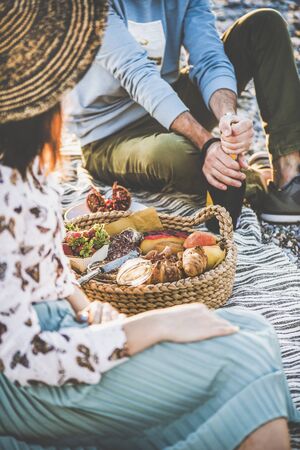 Summer beach picnic at sunset.の写真素材