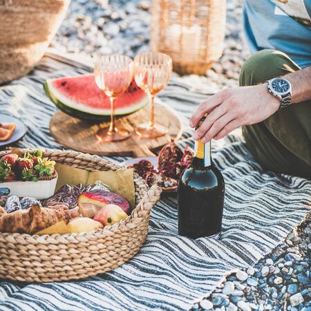 Summer beach picnic at sunset.の写真素材