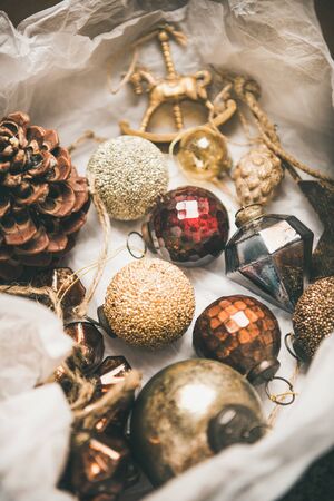 Christmas or New Year preparations. Various vintage Christmas tree decoration toys in box, top view. Festive holiday moodの写真素材