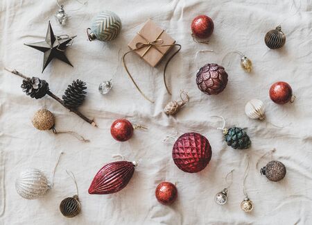 Christmas or New Year holiday background, texture and wallpaper. Flat-lay of Christmas festive decoration toys over beige linen cloth, top view. Preparation for winter holiday seasonの写真素材