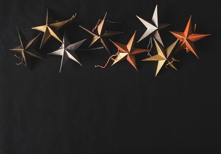 Christmas or New Year holiday decorative stars over blackの写真素材
