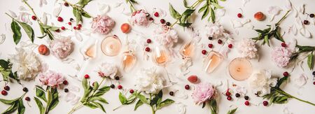 Rose wine variety layout. Flat-lay of rose wine in various glasses with flowers and summer fruit...