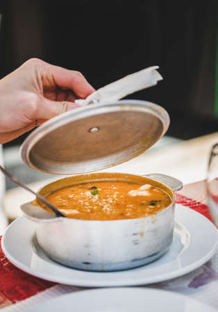 Pot of Portuguese traditional dish Arroz de Marisco or seafood rice on table in local cafe in Lisbon, Portugal. Portuguese national cuisineの写真素材