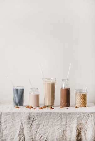 Almond dairy-free milk with matcha, berries, cocoa, coffee in bottlesの写真素材
