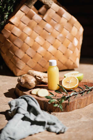 Ginger shot fresh immune boosting juice in bottle with ingredientsの写真素材
