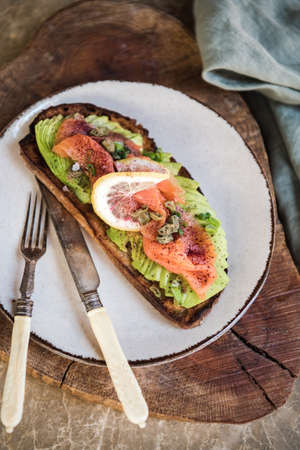 Flat-lay of healthy sourdough avocado toast with smoked salmonの写真素材