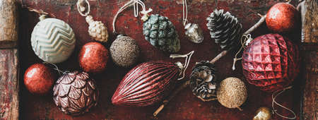 Flat-lay of Christmas decorative toys over red wooden background, close-upの写真素材
