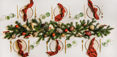 Flat-lay of festive Christmas table setting with dinnerware and decorationsの写真素材