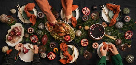 People feasting with roast chicken and hot wine for Christmasの写真素材