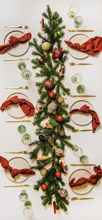 Flat-lay of festive Christmas table setting with decorations, vertical compositionの写真素材