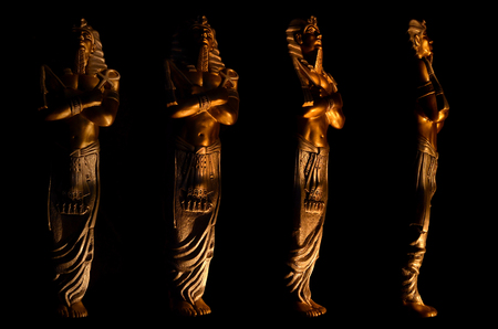 Statues of king pharaoh gods dead religion symbol isolated on black background.の写真素材