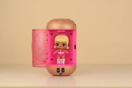 Colorful plastic LOL doll and toys container on table. LOL Surprise series toys manufactured by MGA...