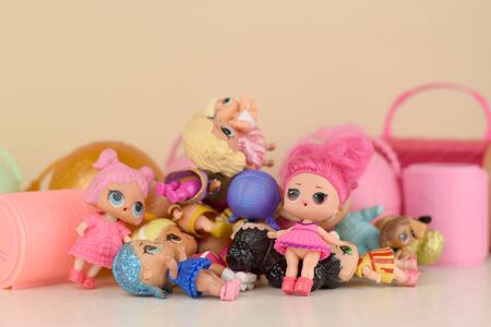 Many colorful plastic LOL dolls on table. LOL Surprise series toys manufactured by MGA Entertainment inc.のeditorial素材