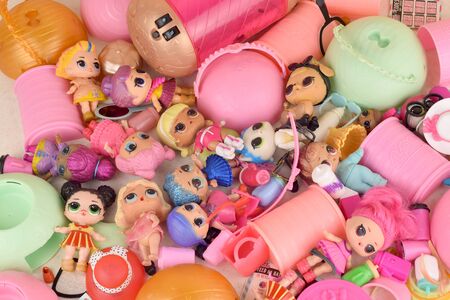Many colorful plastic LOL dolls on table. LOL Surprise series toys manufactured by MGA Entertainment inc.のeditorial素材