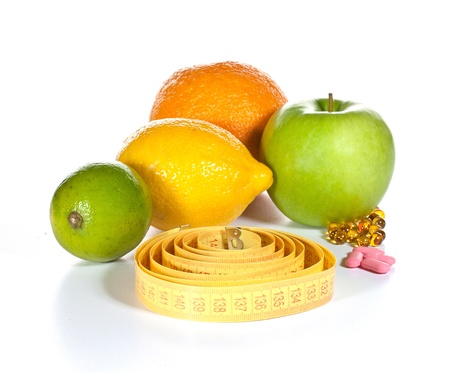Tape measure, diet pills and fruits isolated on a white backgroundの写真素材