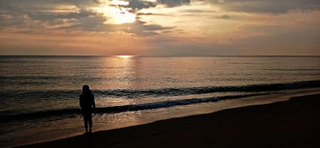 the view of the sunset on the beautiful beach shaded children