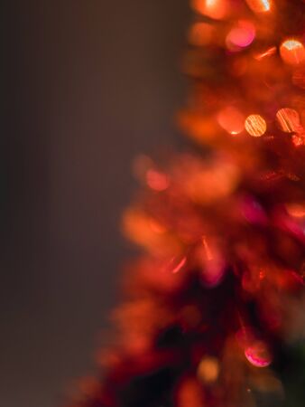 Abstract red New Year's tinsel on a dark backgroundの写真素材