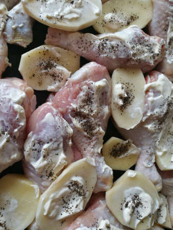 raw chicken legs and potatoesの写真素材