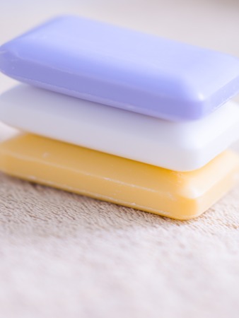 three bars of soap on a brown towelの写真素材