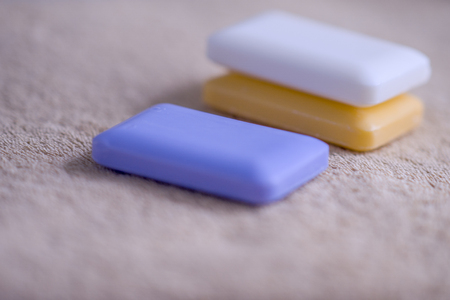 Three bars of soap on a brown towelの写真素材