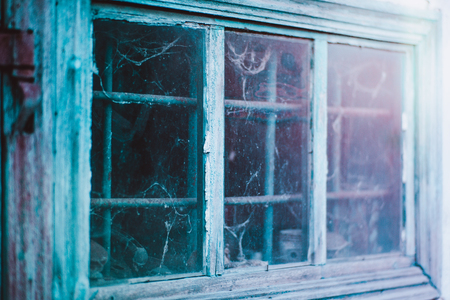 old window with grill and wood frame with peeling paint.の写真素材
