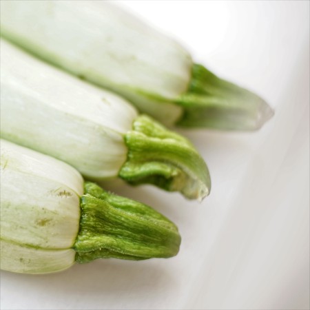 Three fresh vegetable marrow lies on windowsill. Closeup, diagonal viewの写真素材