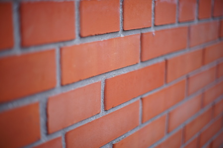 Perspective of a red brick wall, selective focus.