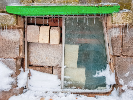 bricks and cinder blocks from the bus window on the front wall with iciclesの写真素材
