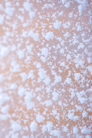 Large snow flakes on the window, macro, close up.の写真素材