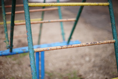 Old iron staircase for children with peeling paint. Blurred backgroundの写真素材