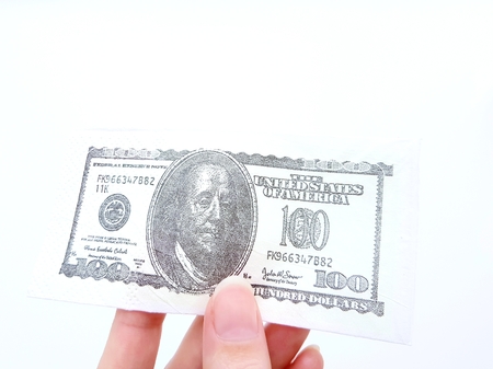 Banknote 100 dollars in hand on a white background.の写真素材