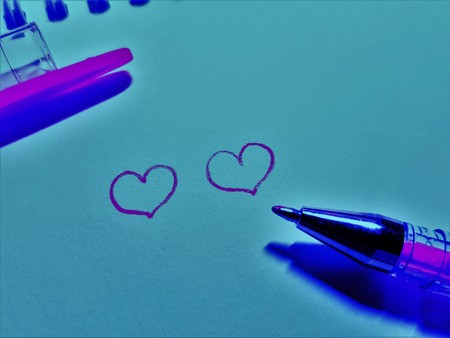 Two hearts drawn on paper with a pen and a cap. Love themeの写真素材
