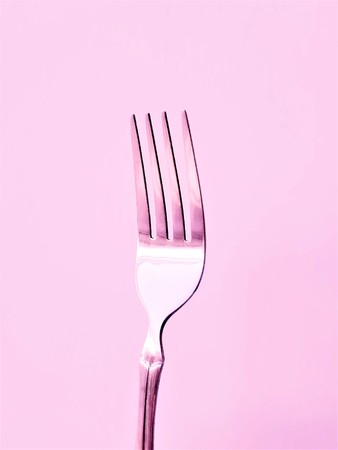 one silver fork in pink tone close upの写真素材