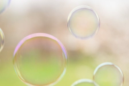 Soap bubbles fly up closeup on natural background of spring garden