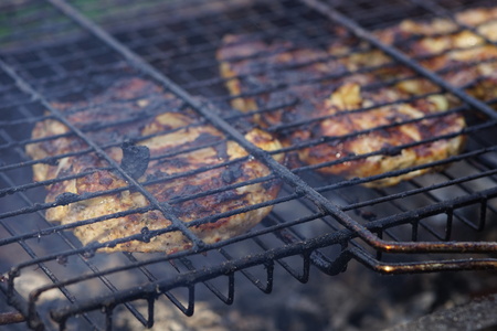 Large pieces of pork meat are prepared in the closed grillの写真素材