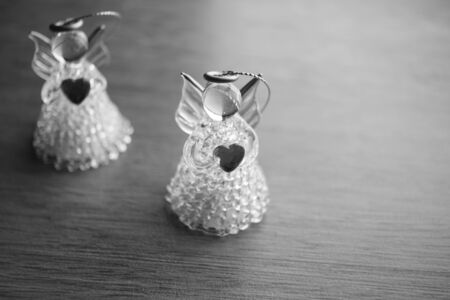 two small statues of angels on the table, bw photoの写真素材