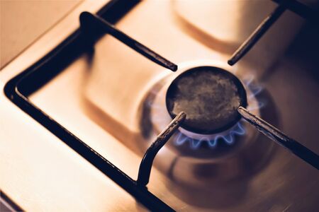 burning gas stove with light in dark room, closeupの写真素材