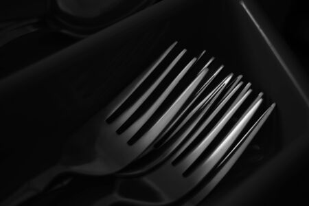 Set of shiny chrome forks in the drawer, bw photo, close-upの写真素材