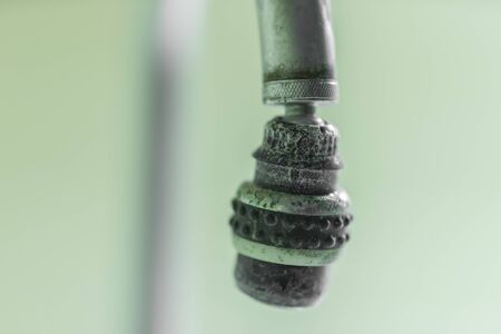 old water tap with a touch of lime.の写真素材