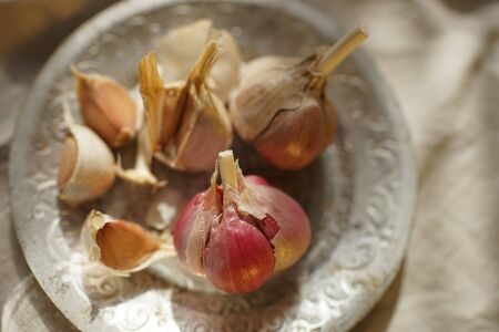 Garlic bulbs and cloves in silver plate. Healthy food.の写真素材