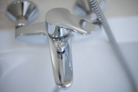 Chrome water tap, top view. Shiny faucet closeup