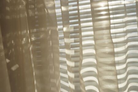 Organza cream tulle with sunshine from the blindsの写真素材