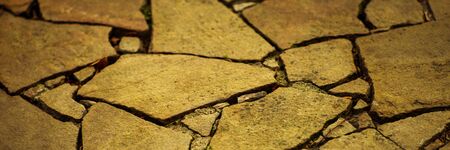 Road surface made of natural wild stones, yellow toneの写真素材
