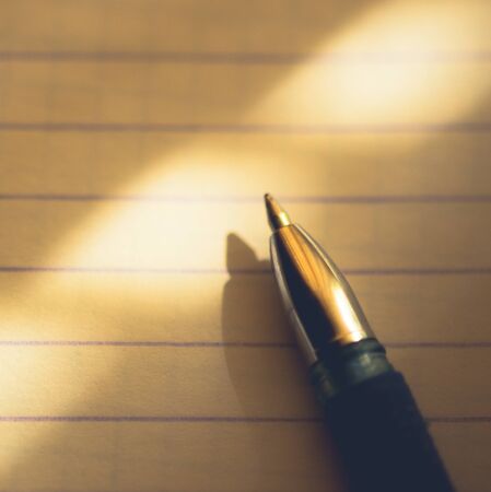 pen on notebook paper in a line, macro photo