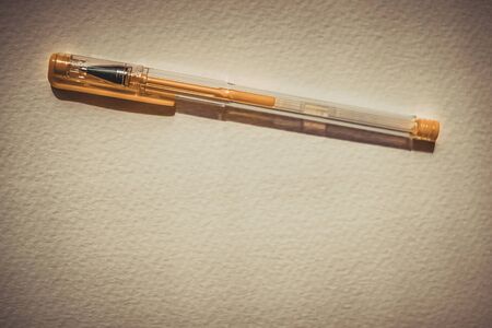 Yellow gel pen on white textured paper, copy spaceの写真素材